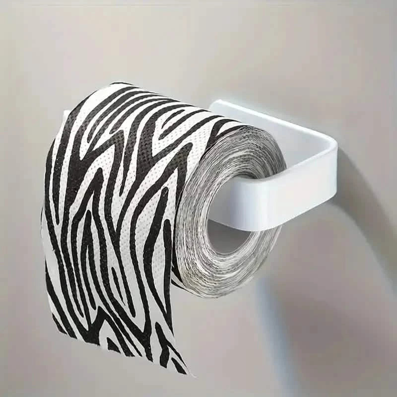 White toilet paper holder holding a zebra-striped toilet paper roll