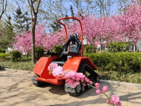 Electric wheelchair with red racer frame and black seat, front view