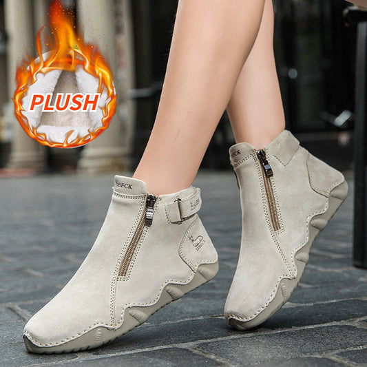 Light beige high-top boots worn with thick cuffs; side zipper and grippy sole visible.
