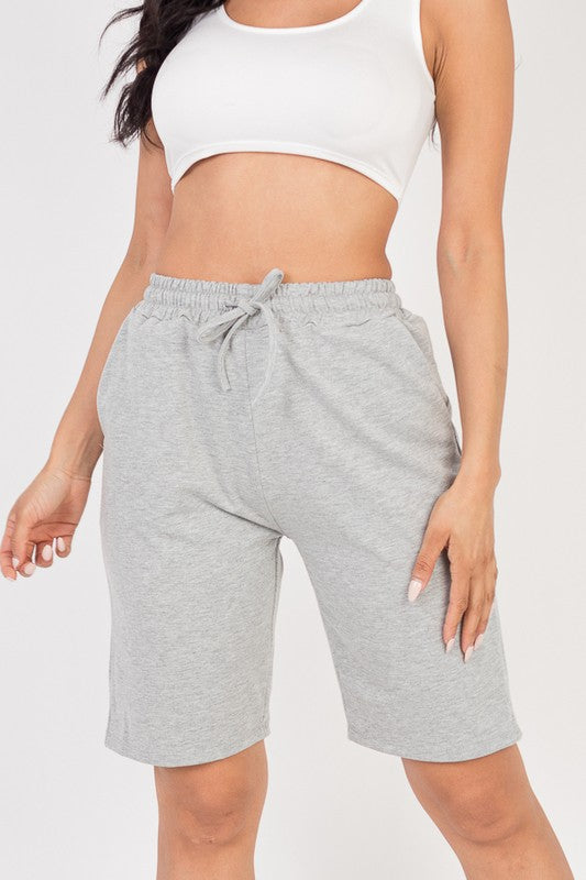 Heather gray french terry bermuda shorts with elastic waistband and drawstring tie