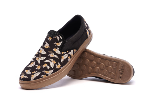 Men's slip-on sneakers with floral fabric upper, black collar, and tan sole