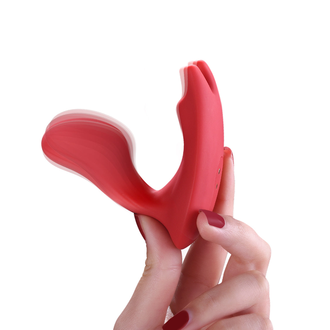 Red dual stimulation vibrator close-up held in hand, two curved tips visible