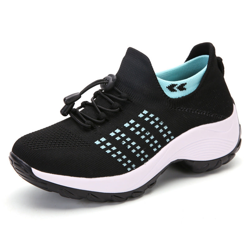 Black knit athletic sneaker with turquoise dotted pattern, lace-up and white cushioned sole