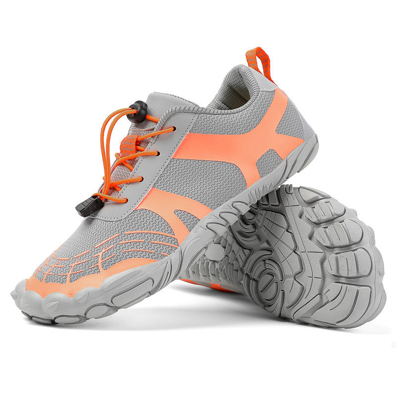 Gray hiking shoes with orange accents and lace-up closure, grippy tread outsole