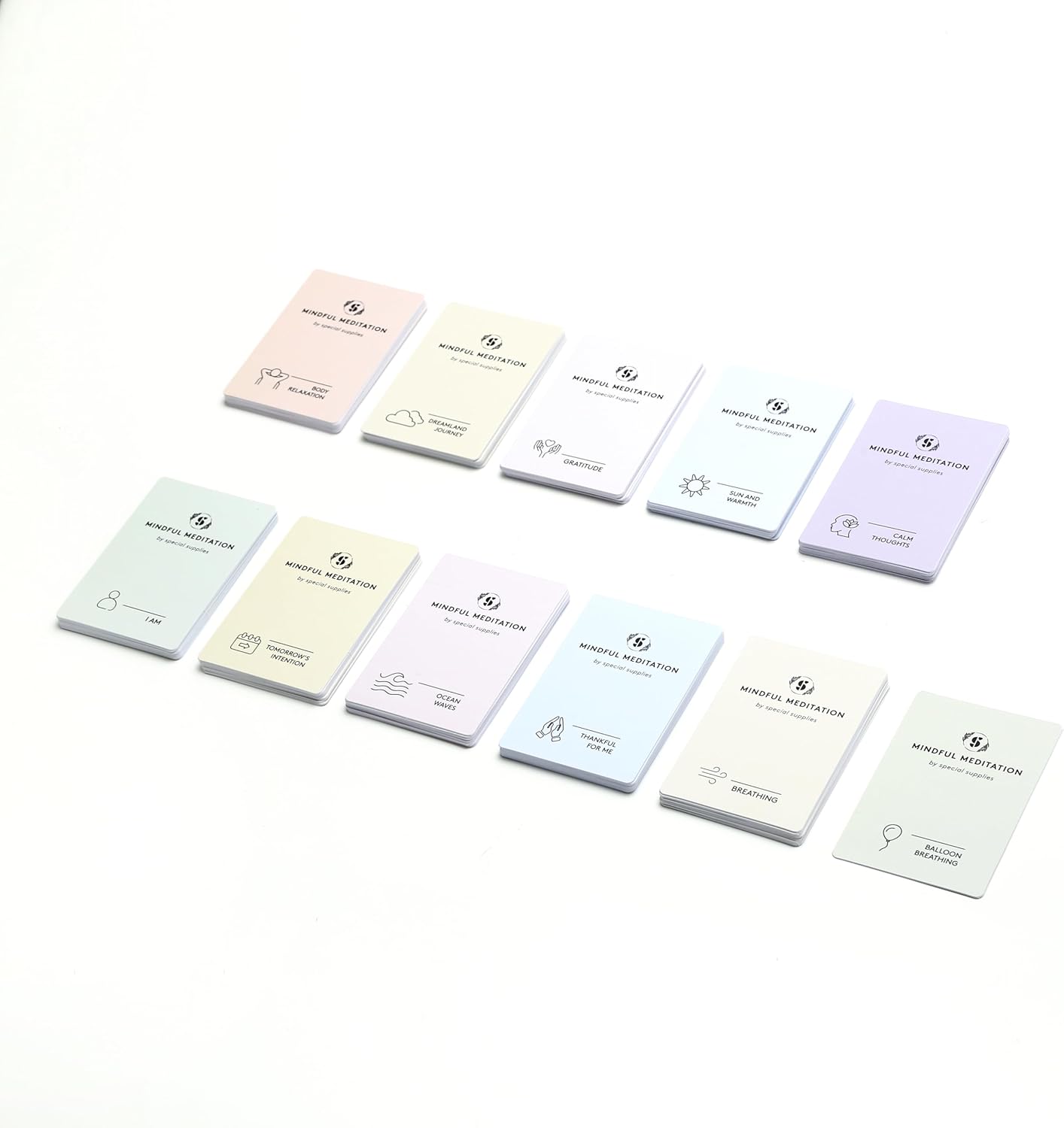 Mindfulness meditation cards with colorful backs and icons, arranged in a loose grid.