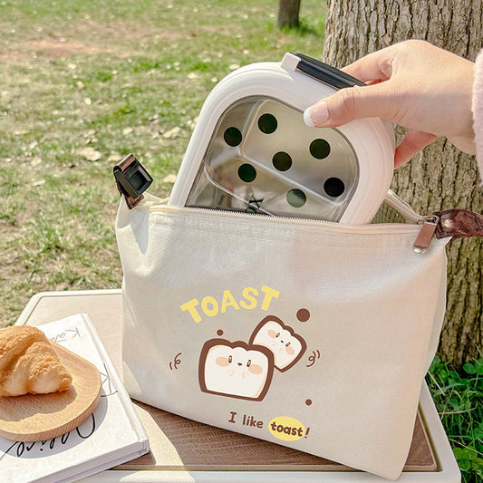 Insulated lunch bag in off-white with “TOAST” lettering, cartoon toast and egg icons