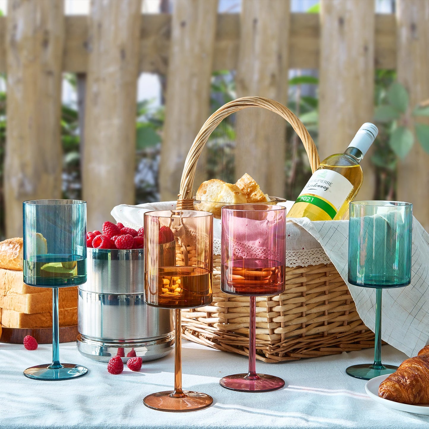 Acrylic stemmed wine glasses in blue, pink, green, and amber with round bases