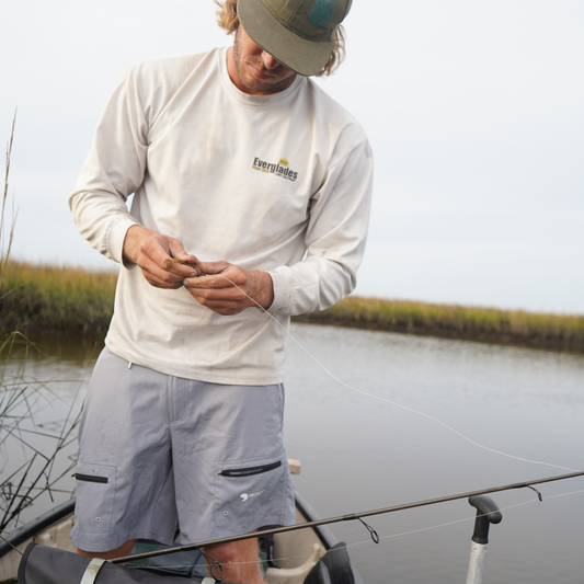 Light gray waterproof shorts with two flap side pockets and elastic waistband