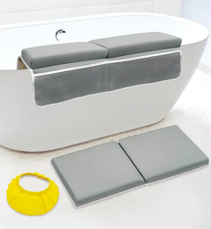 Gray bath seat with mesh back and gray bath mat on a white bathtub.