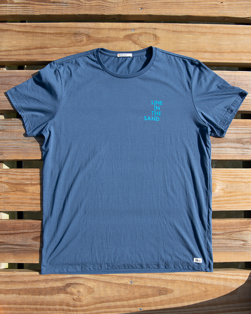 Unisex faded navy wave T-shirt front view with small teal vertical logo