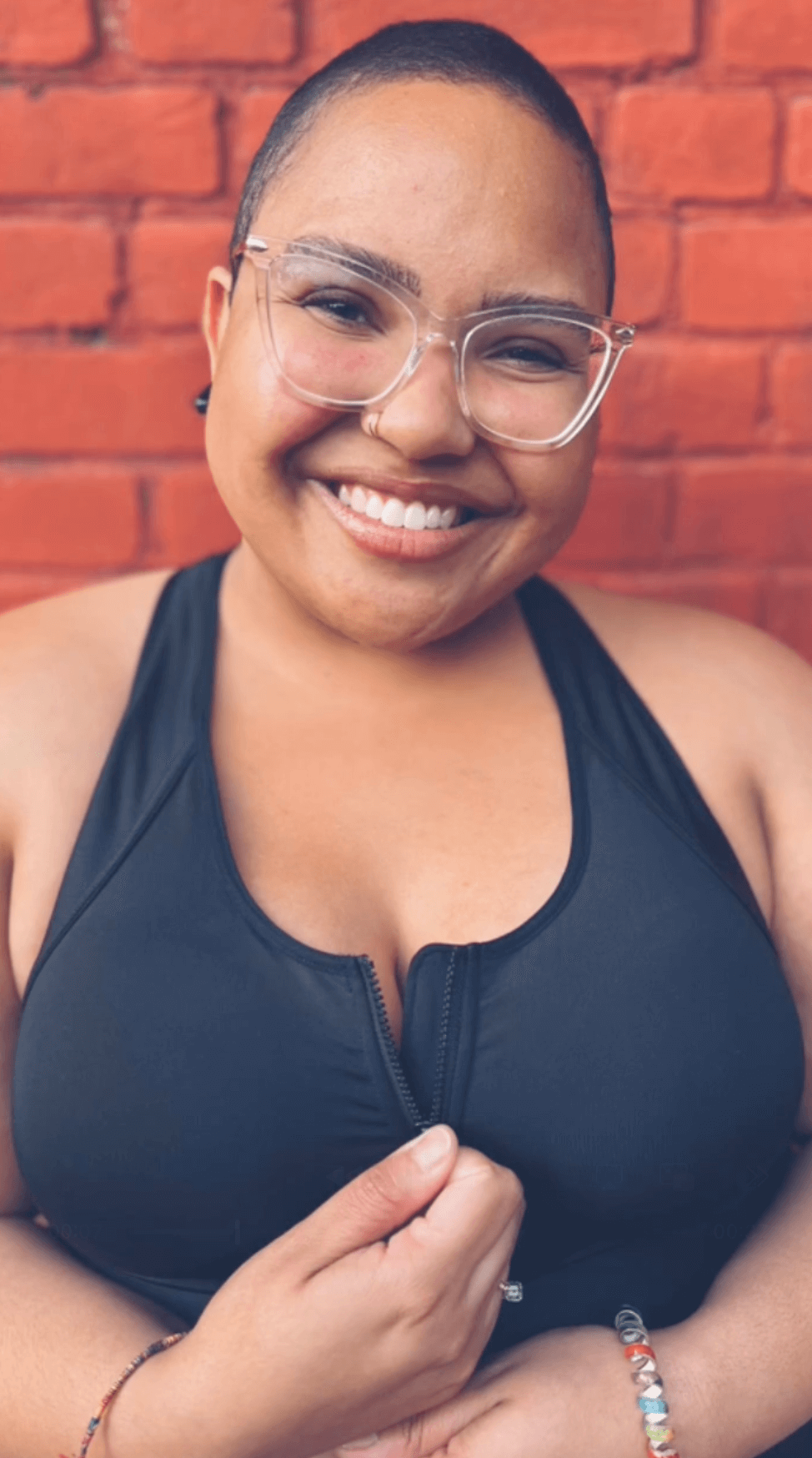 Dark sports bra with front zipper and scoop neckline, close-up on front closure