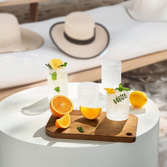 Clear hobnail acrylic tumblers with textured sides and rims, shown with citrus