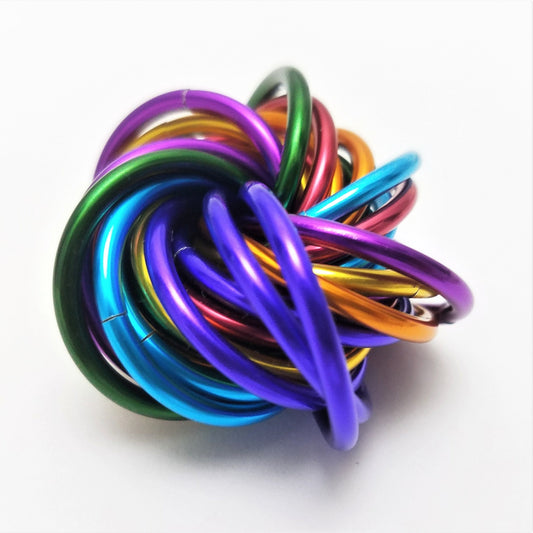 Shiny multicolor coiled fidget stress ball with layered rainbow metal rings