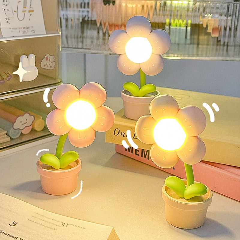 Glowing flower night lights with illuminated petals and green stems in pots