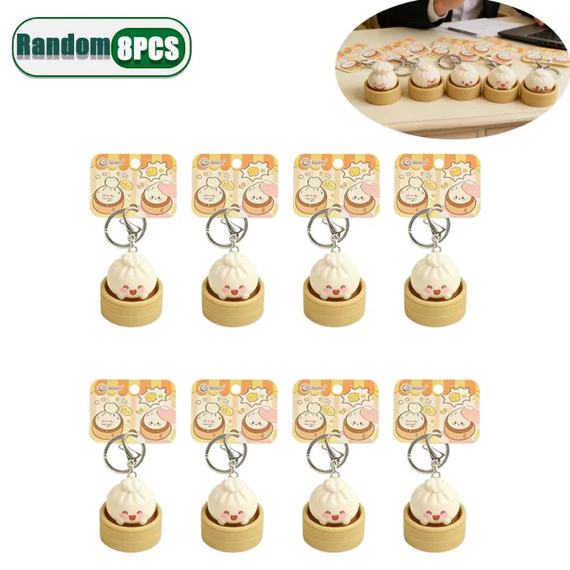 Eight dumpling fidget clicker keychains, tan mini containers with cute faces, metal rings