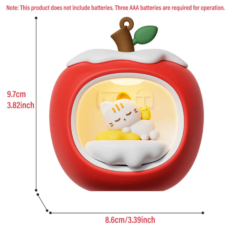 Red apple-shaped night light, front view with sleeping cat in illuminated circular window