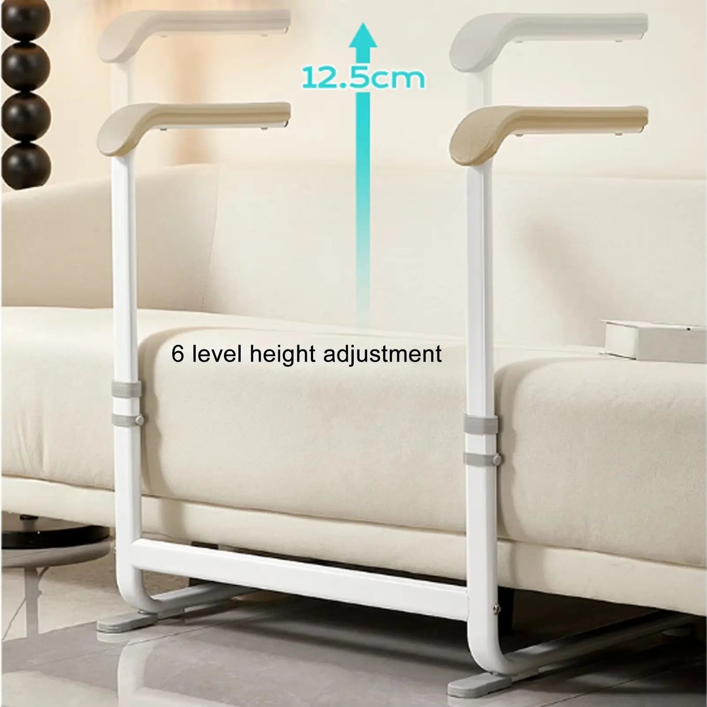 Standing aid with beige handle pads and white frame positioned between couch seats