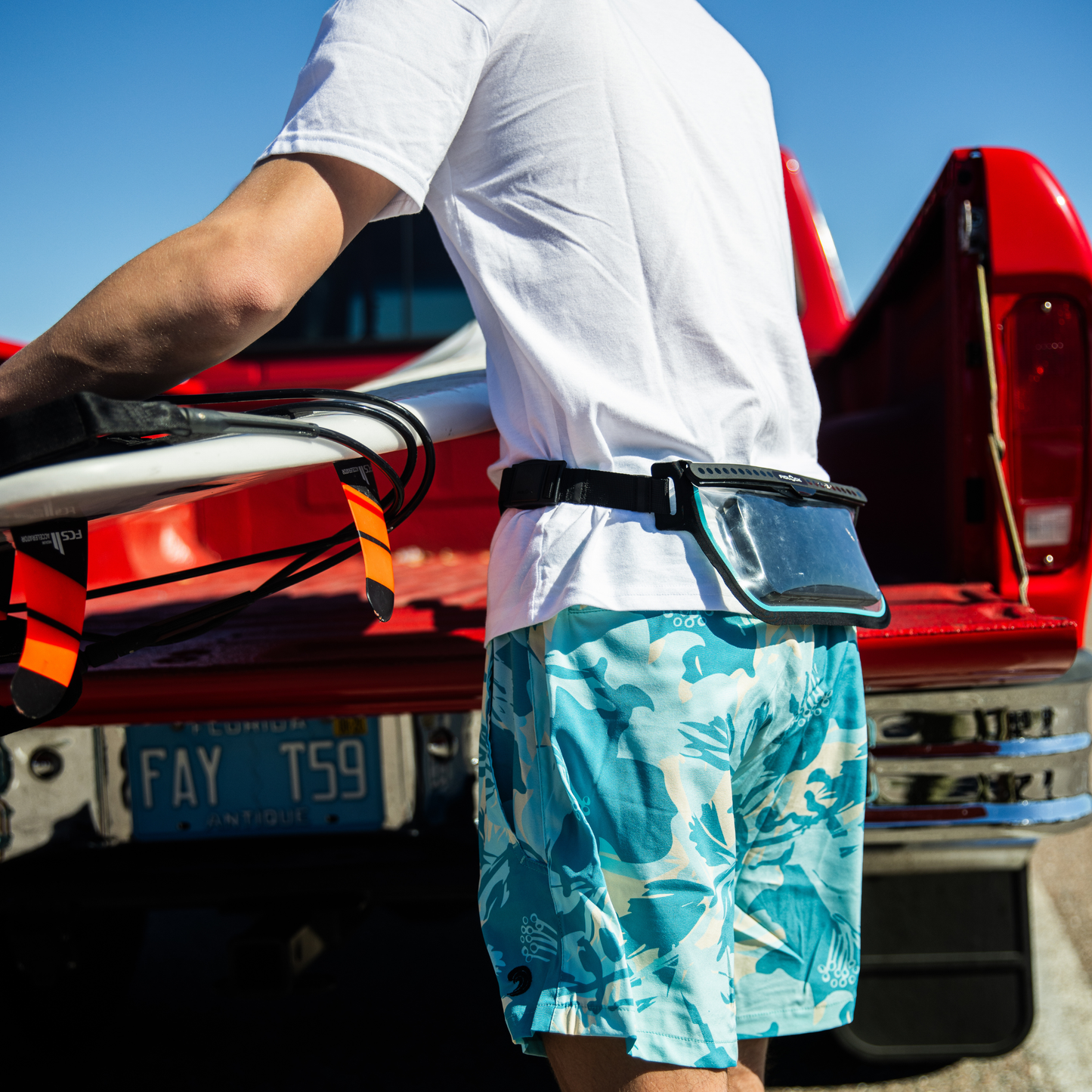 Waterproof fanny pack dry bag on hip with clear window pocket, black strap and blue trim.