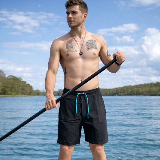 Black waterproof swim shorts with elastic waistband and drawstring.