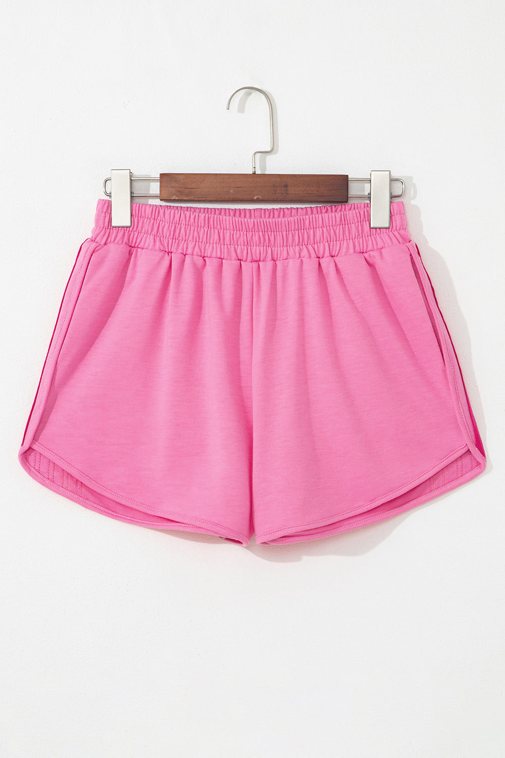 Pink high-waist active shorts with elastic waistband, no side stripes