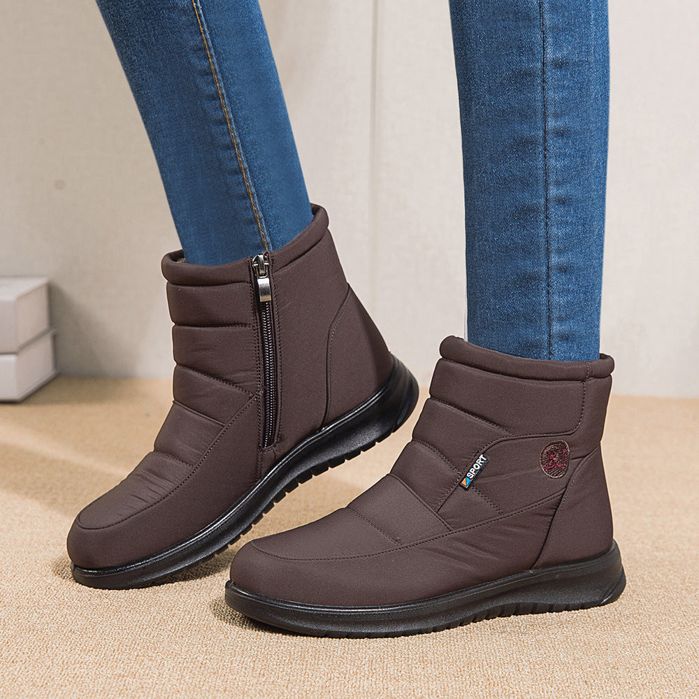 Women’s brown ankle boots with side zipper and black rubber sole