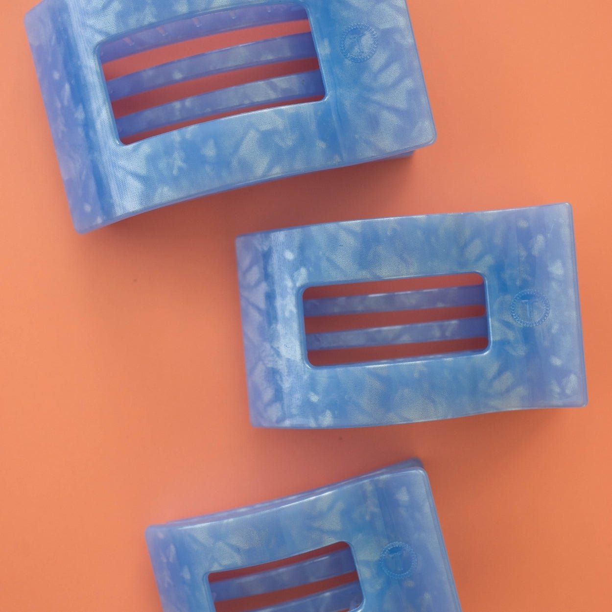 Set of three translucent light blue rectangle hair clips with three horizontal slots