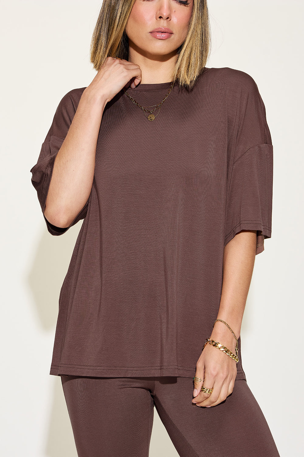 Chocolate brown drop-shoulder t-shirt and flare pants set, close-up
