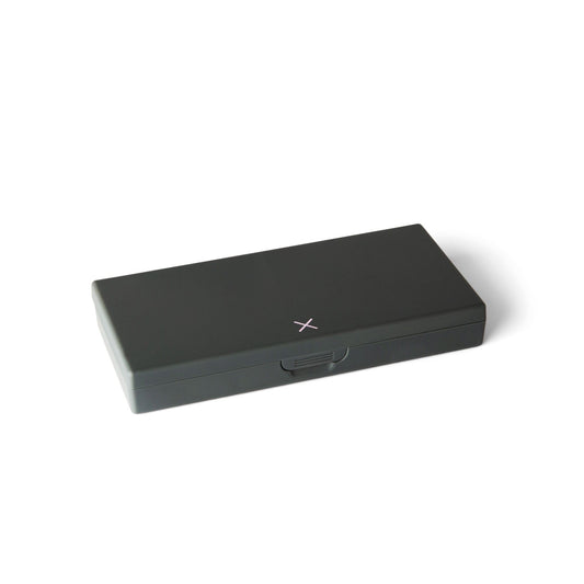 Charcoal gray pill box with flip-top lid closed and small center latch mark