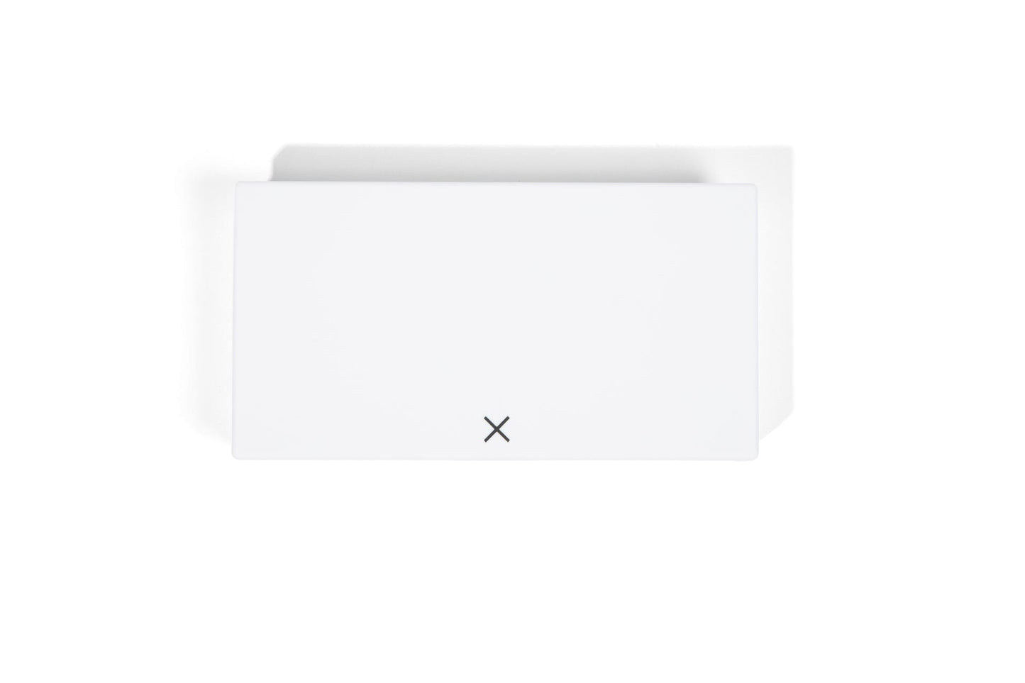 White pill box with closed lid and small X symbol on the front