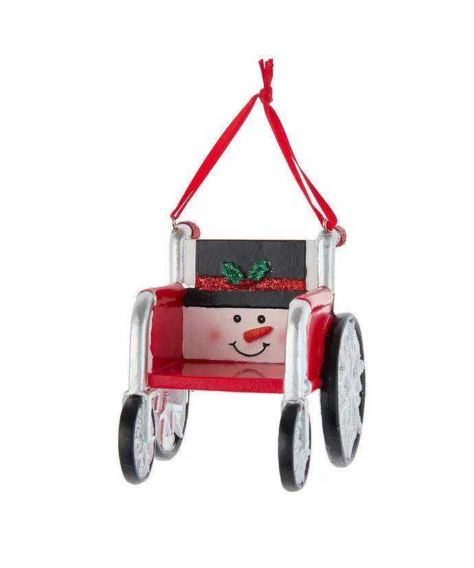 Snowman wheelchair ornament with red seat, silver wheels, and green bow on back