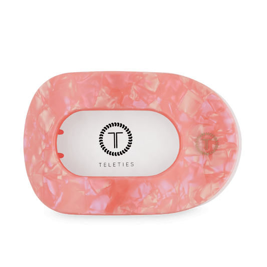 Large flat round hair clip, translucent pink, with Teleties logo on back