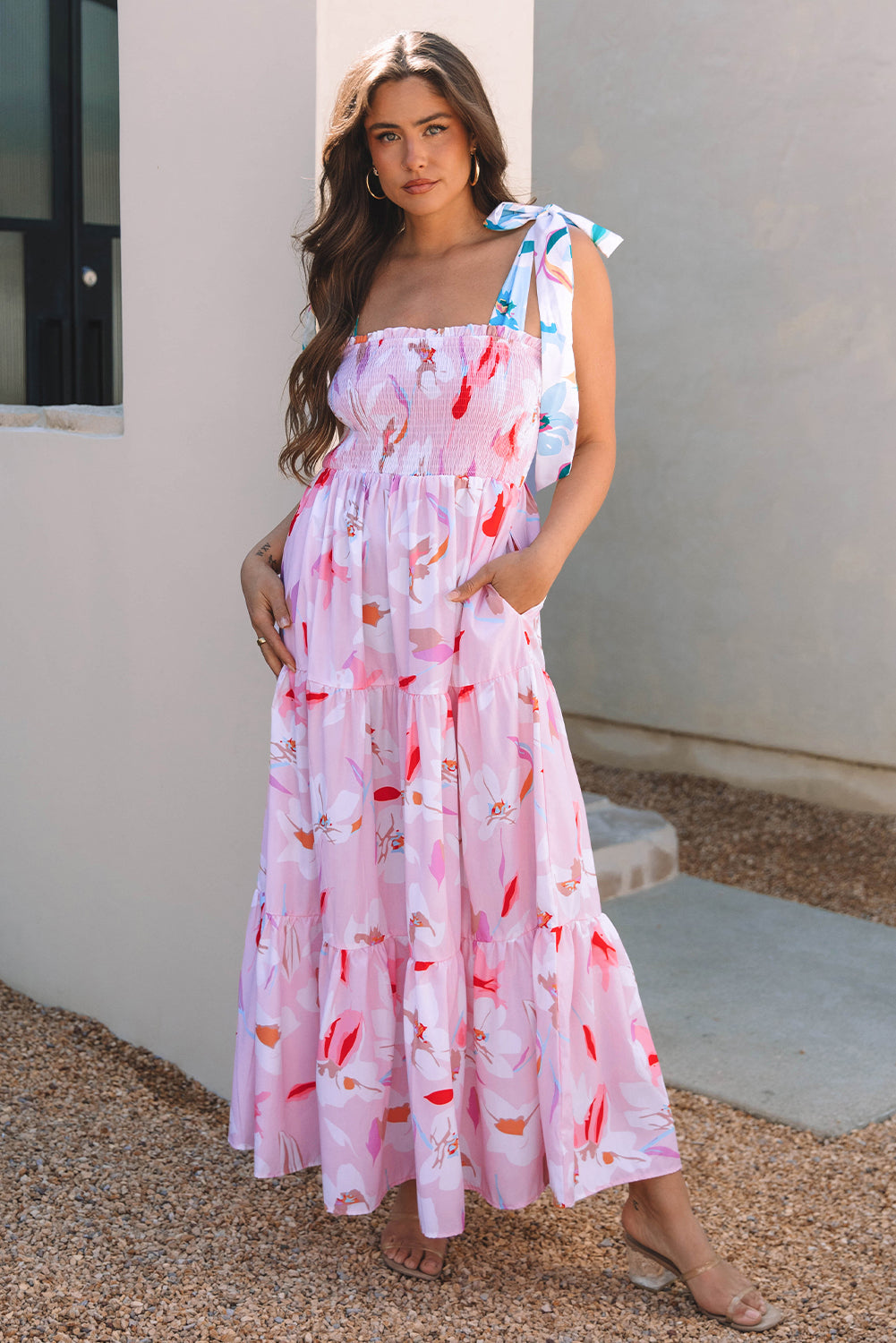 Pink floral smocked maxi dress with tiered ruffles and knotted shoulder straps