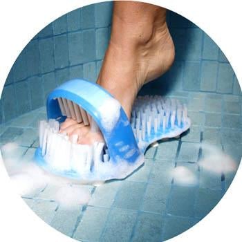 Foot scrubber being used on foot, blue bristles