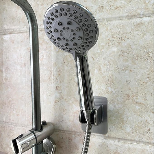 Wall-mounted handheld shower holder with chrome bracket and round shower head base.