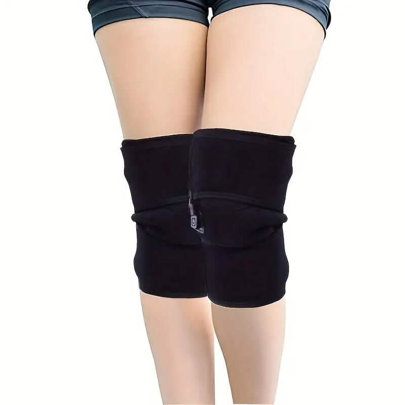 Black heated knee sleeves worn on legs, front controller module with power cord