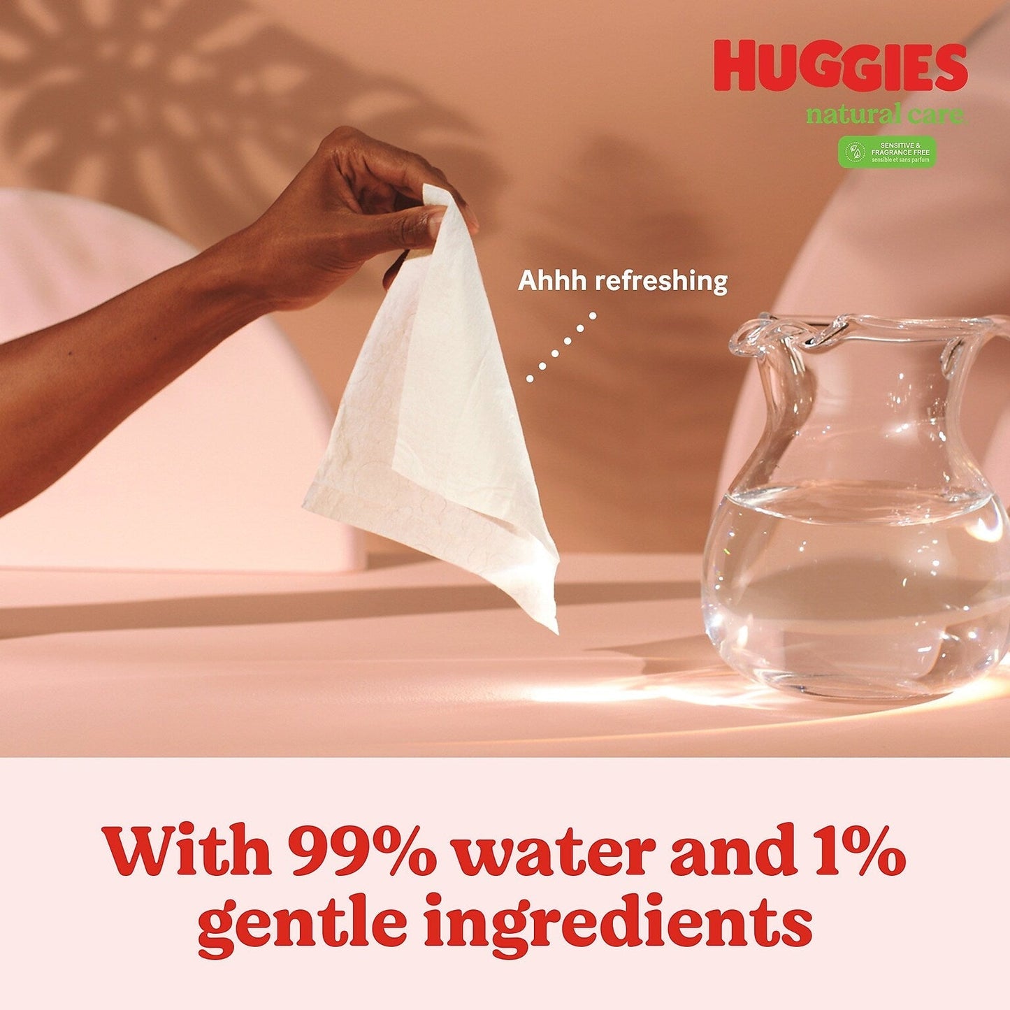 Fragrance-free baby wipe being pulled open near a water jug