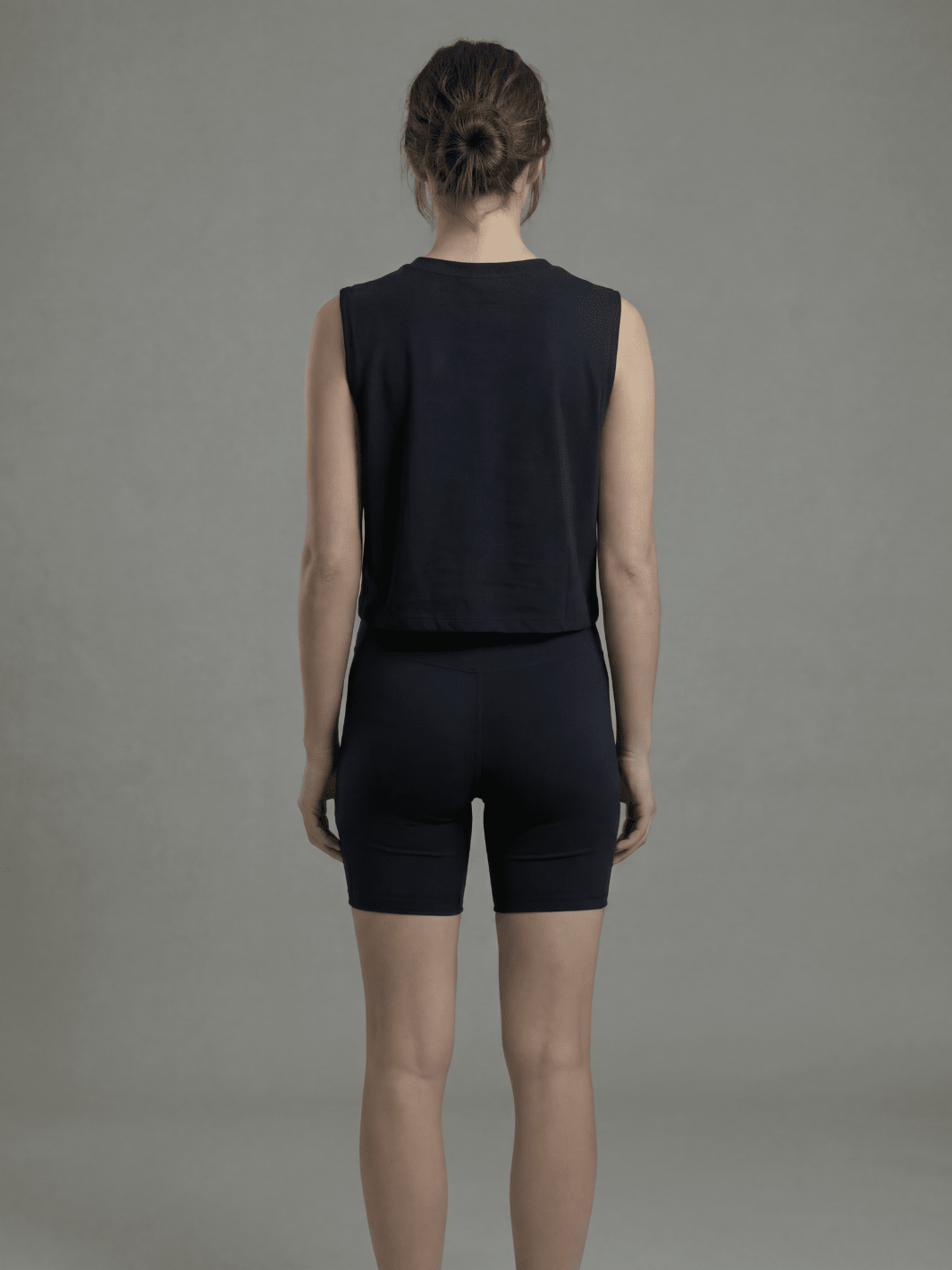 Black muscle tank shown from the back, sleeveless with crew neckline