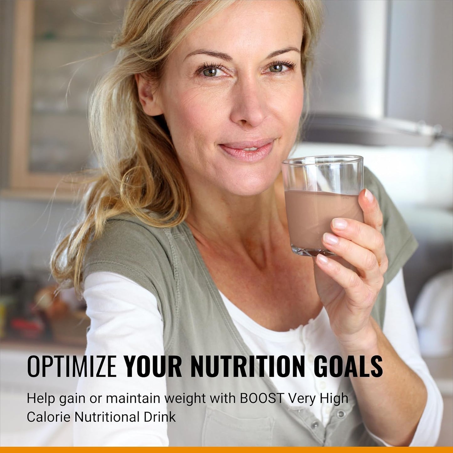Woman holding a glass of Boost VHC chocolate nutritional drink, 8 fl oz carton
