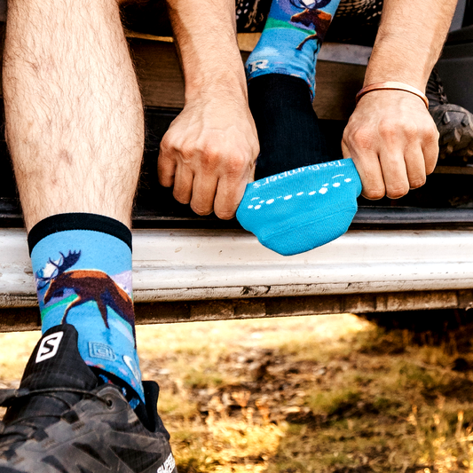 Cushioned toe-protection socks, bright blue worn on feet with dotted toe detail