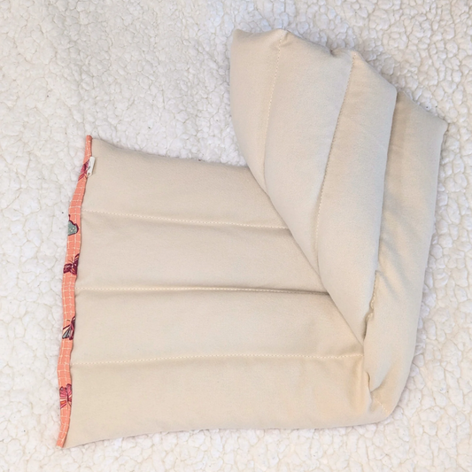 Weighted heating pad folded, smooth cream flannel back with stitched channels