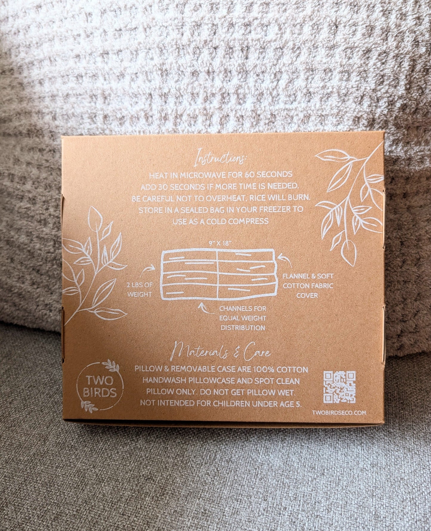 Back of weighted heating pad box with material and care instructions diagram