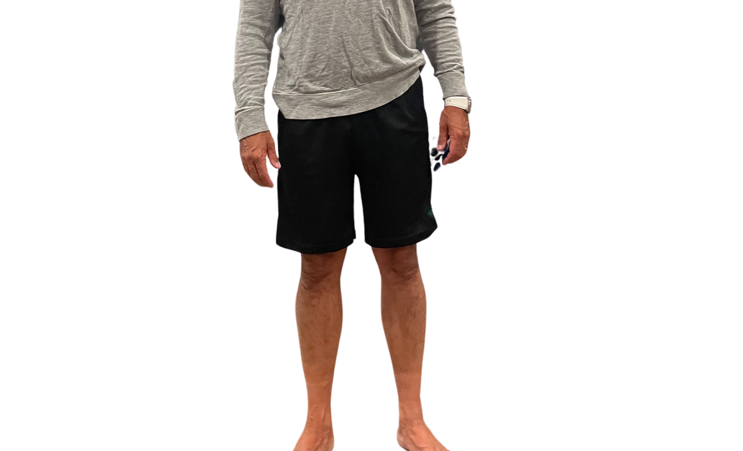 Person wearing a gray long-sleeve shirt and black shorts on a white background