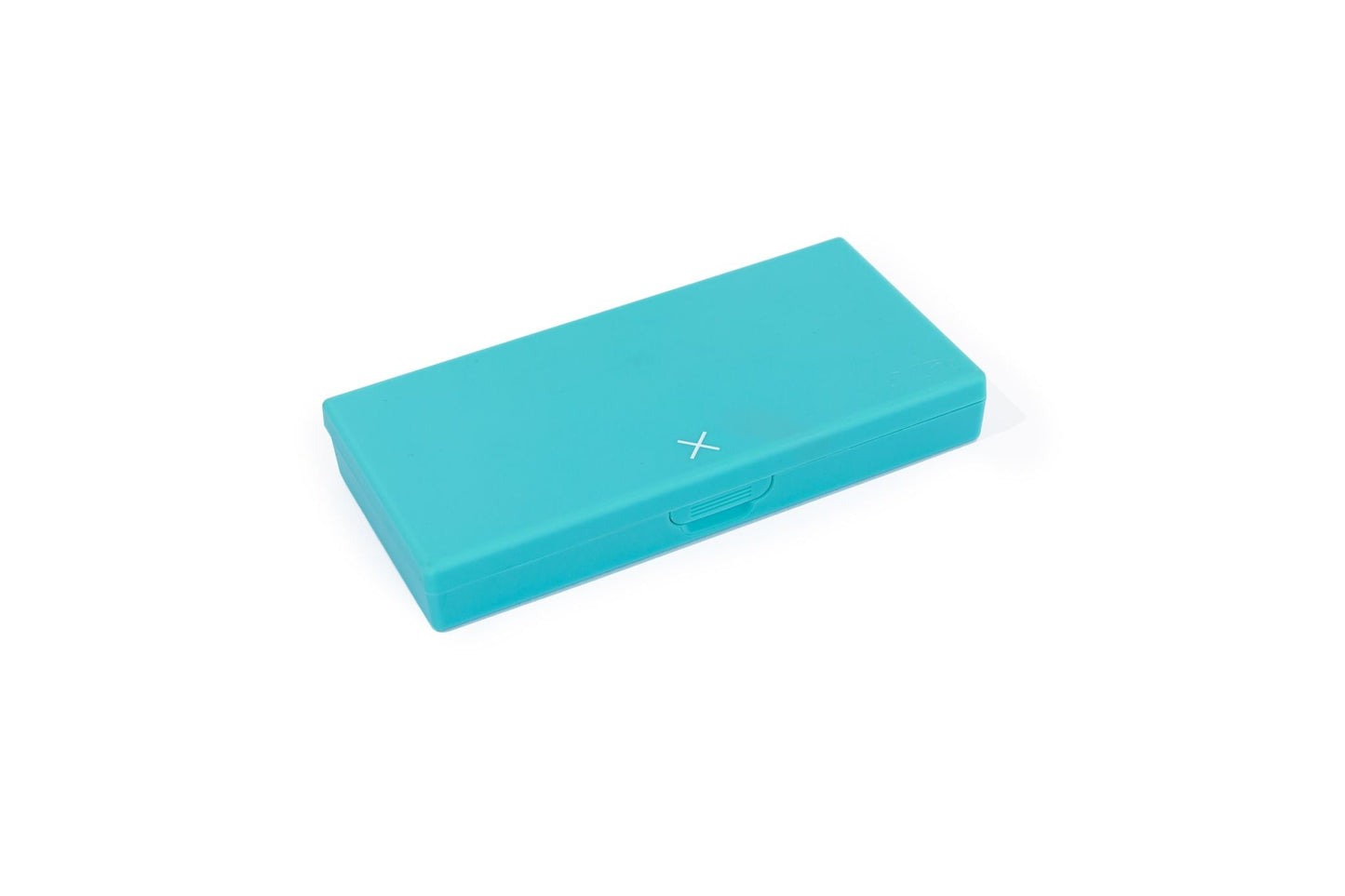 Teal pill box, closed, with small X on side