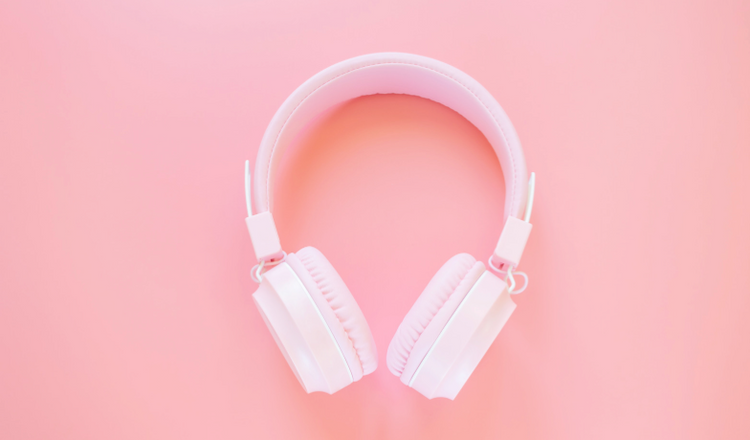 White noise canceling headphones on a pink background