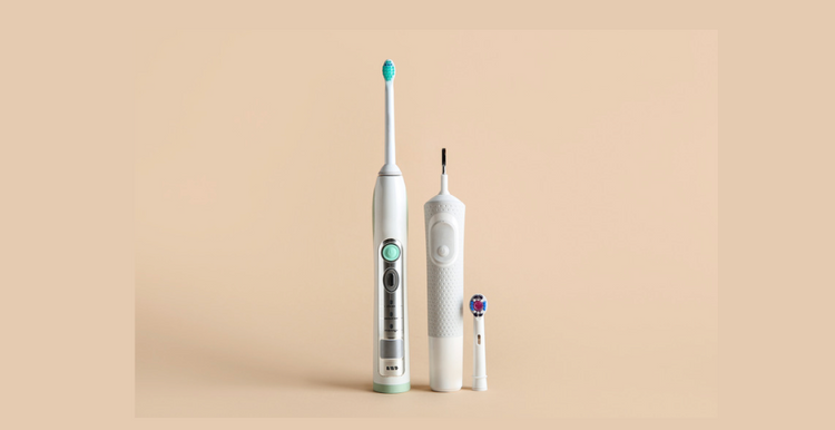 Electric toothbrush on beige background