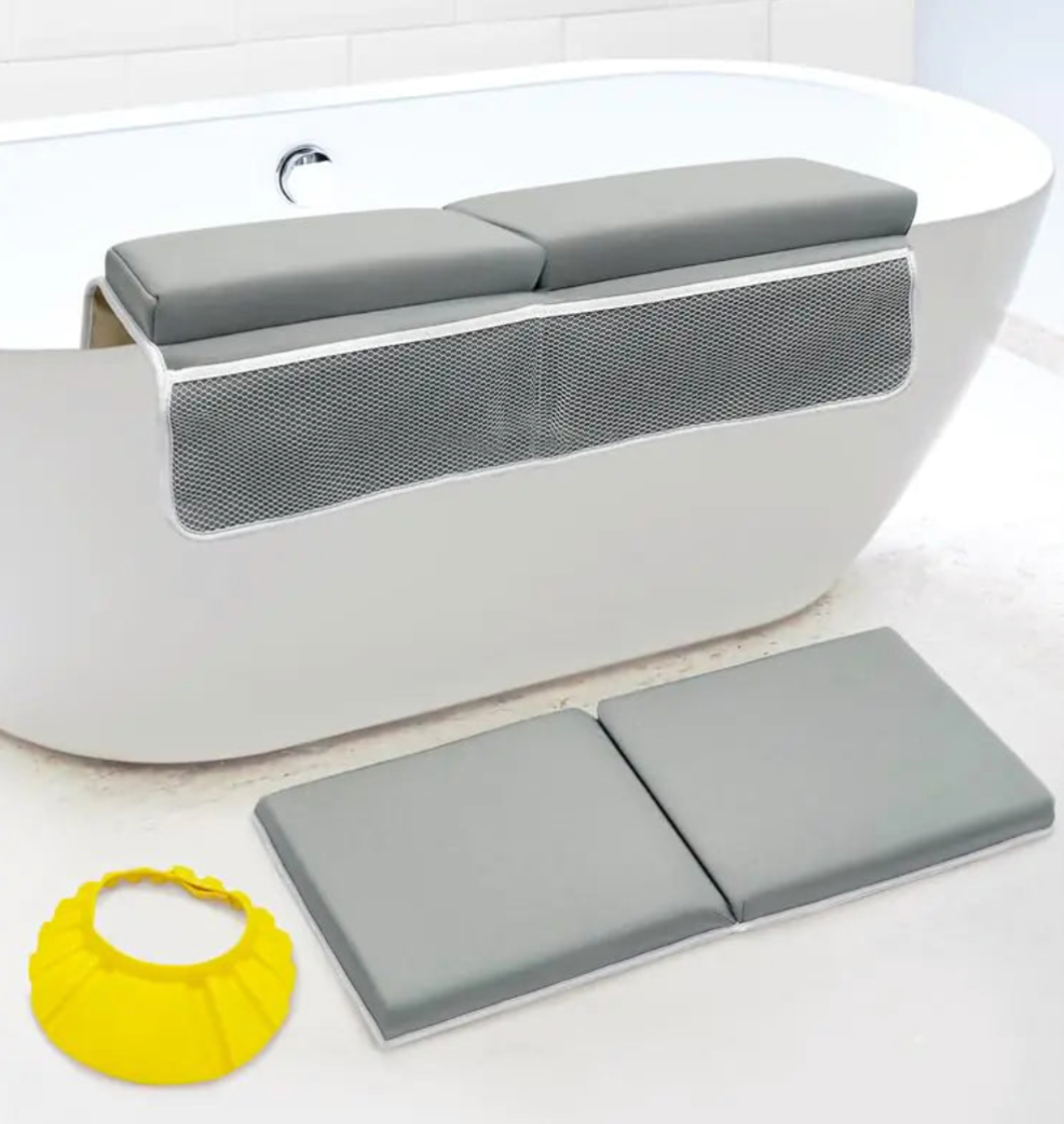 Gray bath seat with mesh back and gray bath mat on a white bathtub.