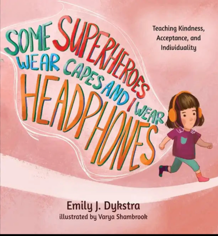 Hardcover picture book with colorful title and cartoon child wearing headphones and cape "Some Superheroes Wear Capes and I Wear Headphones