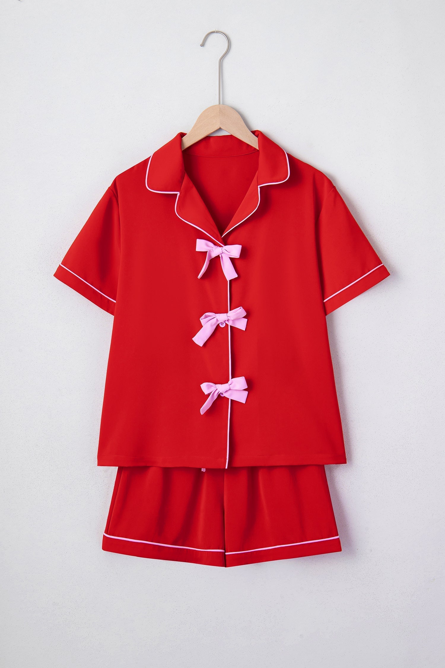 Short sleeve and shorts pajama set, red with pink piping and pink bows down the center