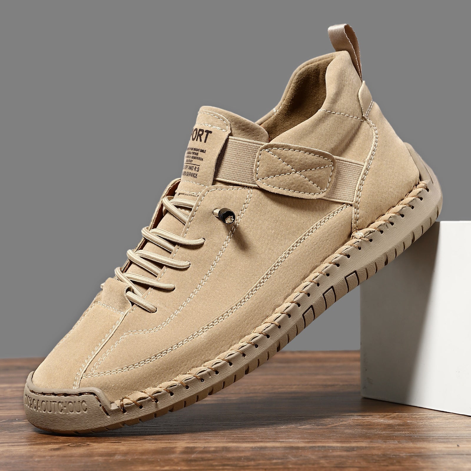 Casual leather boots in tan with lace-up front, side strap, and stitched rubber tread sole.