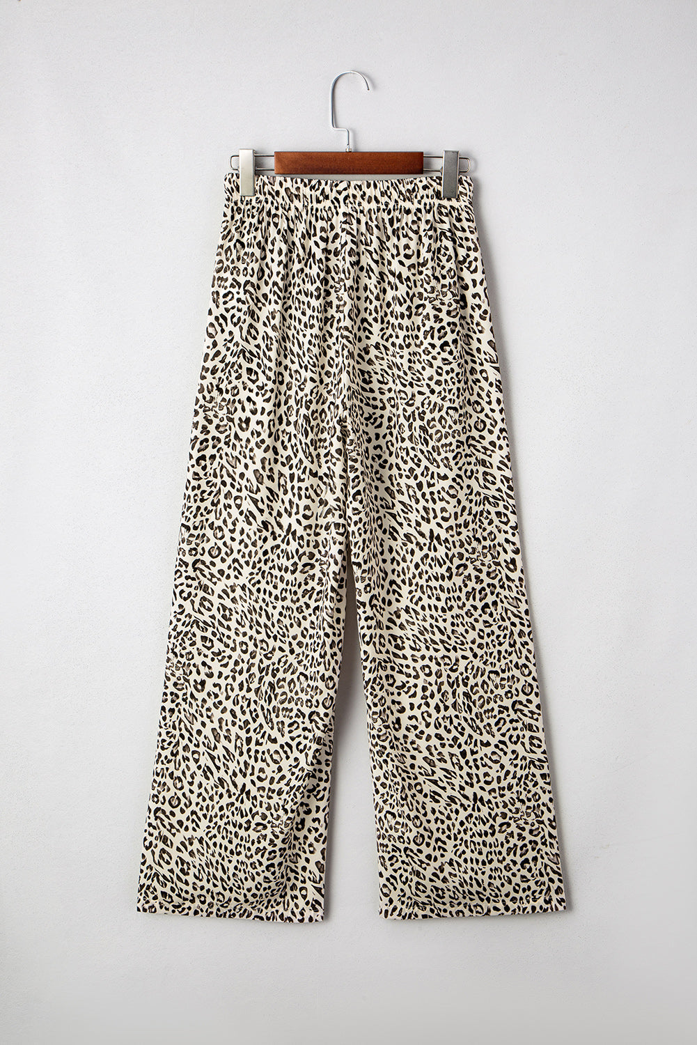 Leopard print wide-leg pants on hanger with drawstring elastic waistband, brown and cream.